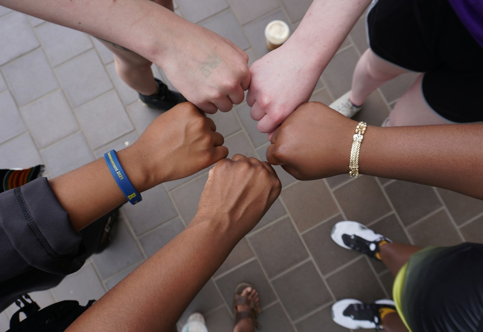 A diverse group joining hands in a circle